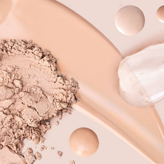 Close-up of Mirabella makeup liquid and powder swatches on top of a light pink background.