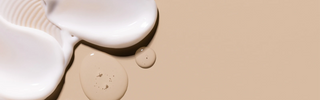 Abstract skincare texture with soft cream and liquid drops on beige background, symbolizing Mirabella Clarifying Serum and SPF 30 Primer duo.