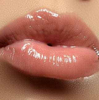 Close-up of super glossy shimmer lips wearing Mirabella Glow Light Up Lip Gloss – clear, high-shine finish with reflective sparkle