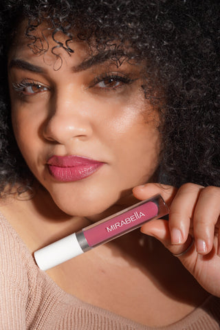 Lisha posing with Mirabella Beauty Luxe Advanced Formula Lip Gloss in Rich Berry Rose for glossy, hydrated-looking lips.
