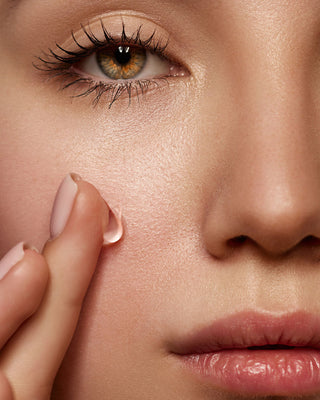 Close-up of model's cheek showing a visible swatch of Mirabella Beauty’s Prime for Face makeup primer on bare skin.