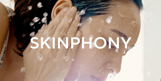 Model rinsing face with water while cleansing, overlaid with SKINPHONY text promoting Mirabella Skinphony Pro Face Cleanser