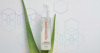 Model with natural glowing skin beside Mirabella Beauty Skinphony Pro Face Cleanser bottle and box on a soft water-textured background.