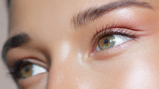 Mirabella Beauty close-up of softly defined brows and long lashes on closed eyes with natural skin texture and neutral eye makeup