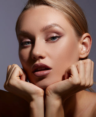 Model wearing Mirabella Buff Beauty-inspired makeup – flawless skin with soft contouring, neutral tones, & a natural, polished look