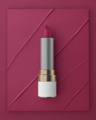 Mirabella Fiercely Fuchsia lipstick from the Sealed With a Kiss collection shown on textured pink background with bold pigment swipes.