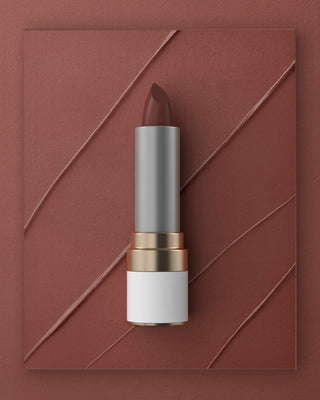 Mirabella Not Your Avg. Nude lipstick from the Sealed With a Kiss collection shown on textured warm nude background with soft pigment swipes.