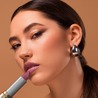 Model wearing Mirabella Soft Satin lipstick in Pink Quartz paired with clean glowing makeup for a radiant soft shimmer look.