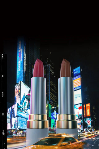 Mirabella Bold in the City lipstick launch featuring Not Your Avg. Nude and Fiercely Fuchsia shades towering over NYC with yellow taxi at night.