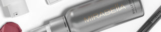 A banner image of Mirabella Beauty's Bulletproof Matte Setting Spray on a white background with swatches and makeup around it.