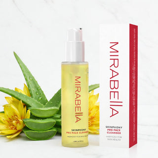 Mirabella Skinphony Pro Face Cleanser bottle and box with aloe leaves and yellow flowers on white marble background.