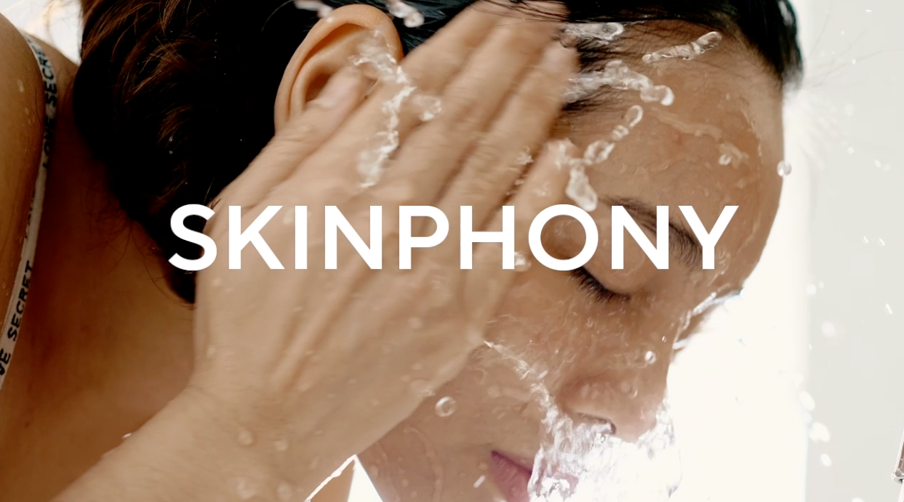 Model splashing water on face during cleansing with Mirabella Skinphony Pro Face Cleanser text overlay