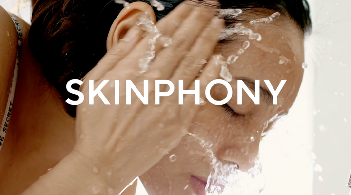 Model splashing water on face during cleansing with Mirabella Skinphony Pro Face Cleanser text overlay